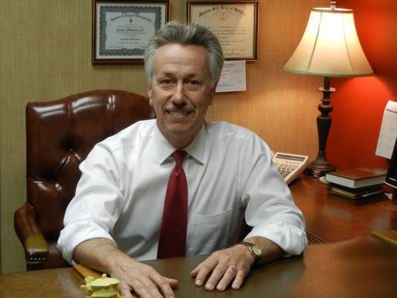 Dr Larry Bompiani sat at his desk